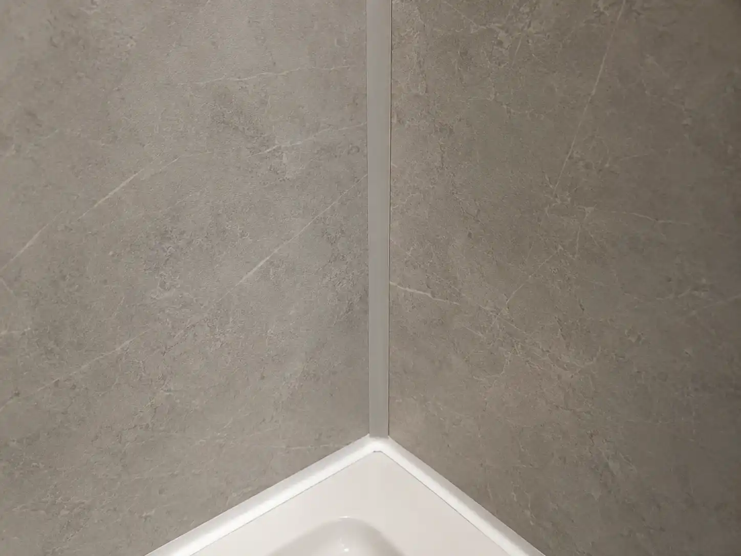 SPC shower wall panel corner trim and sealed edge detail