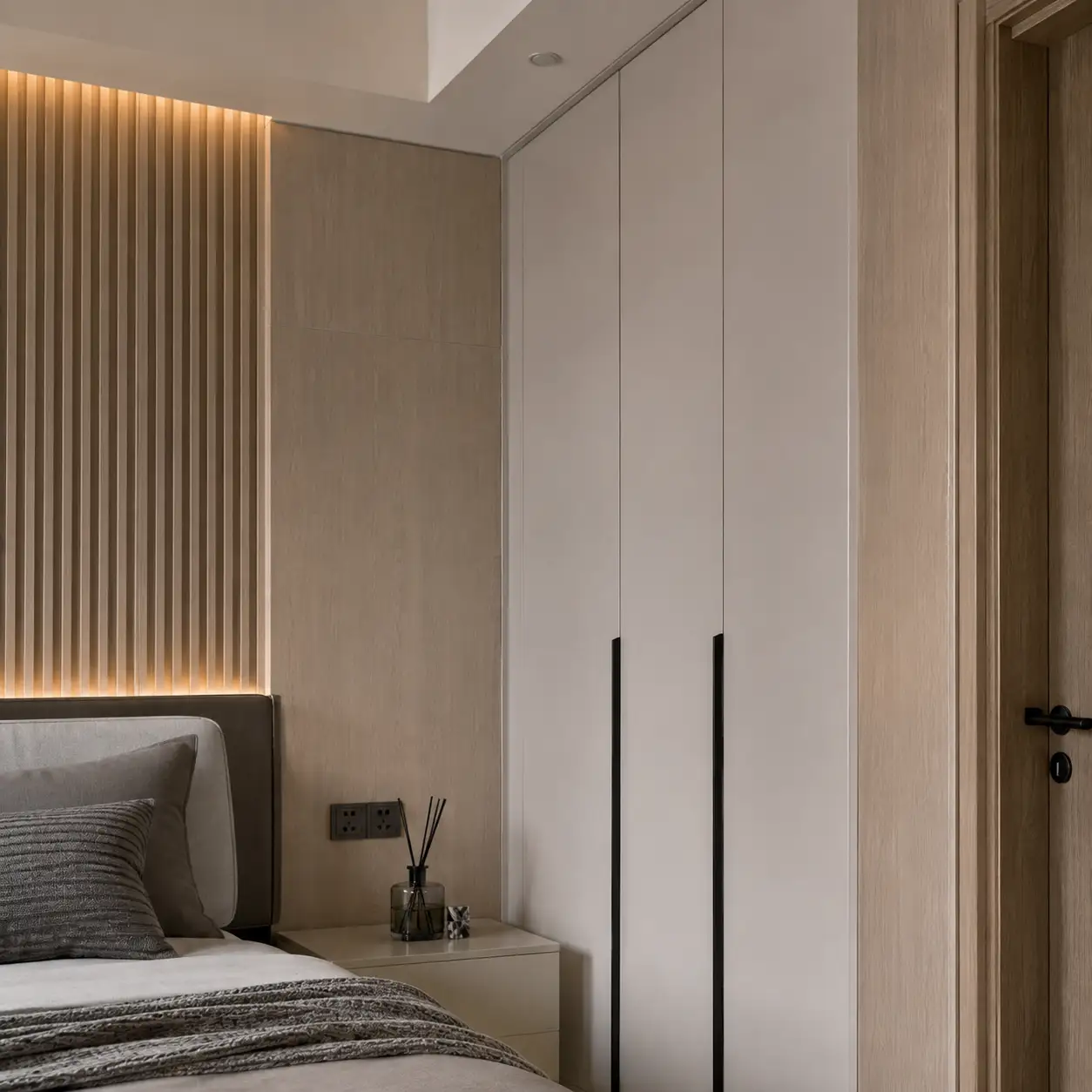 PVC wall panel trim detail around wardrobe edge and bedroom door frame