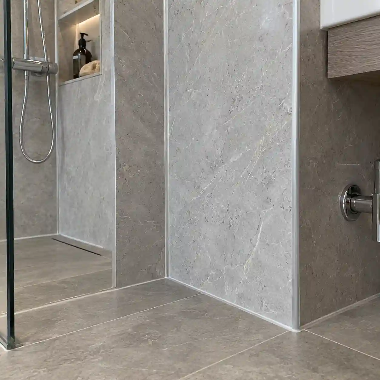 SPC wall panel trims, corner details and sealant lines for wet-area installation